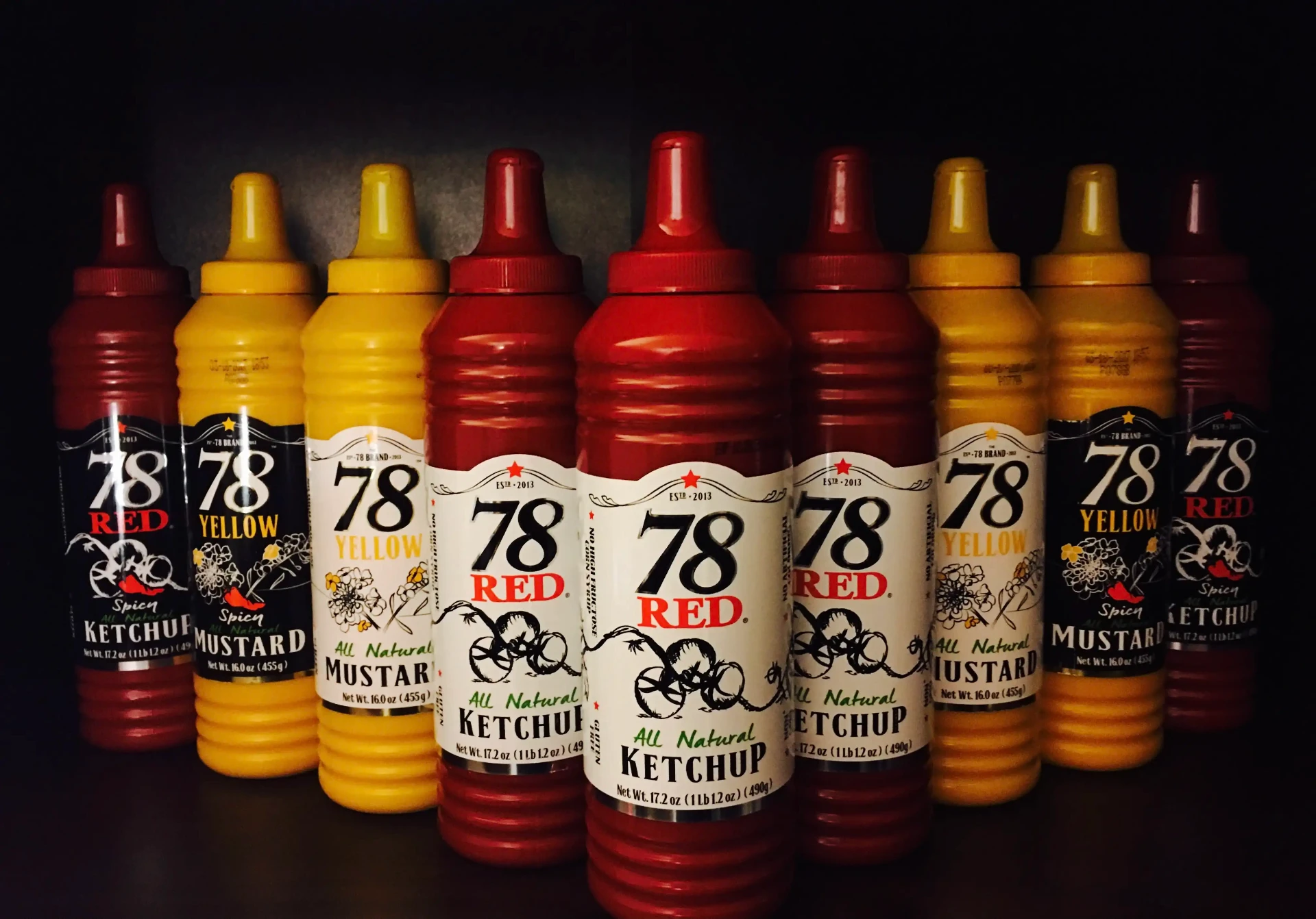 78 Brand ketchup and mustard bottles lined up on a retail shelf