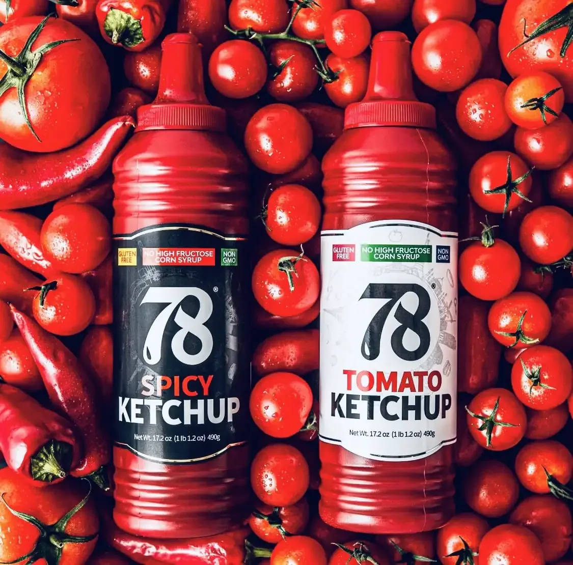 78 Brand Spicy Ketchup and Tomato Ketchup bottles surrounded by fresh tomatoes and chili peppers.